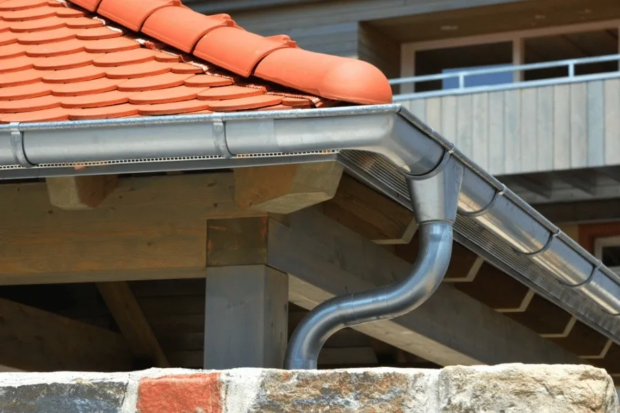 Precision Gutters LLC close-up of aluminum gutter system on tiled home roof
