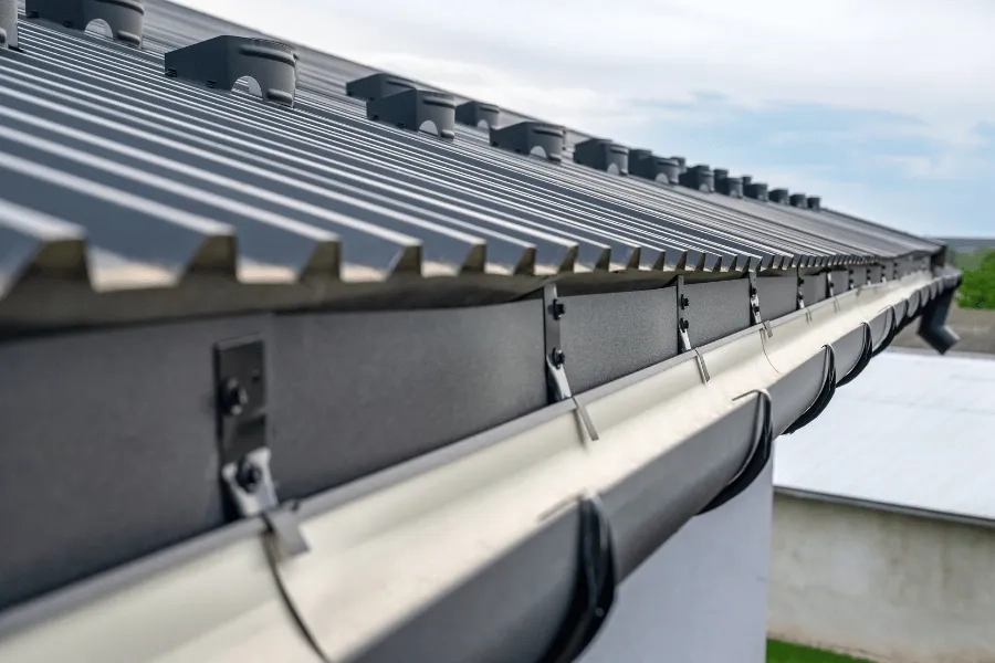 Precision Gutters LLC galvalume gutter installation on metal roof structure