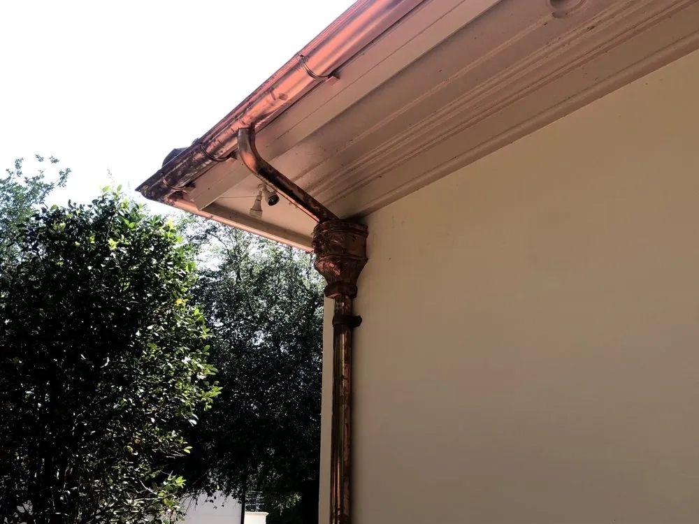 Precision Gutters FL custom copper gutter and decorative downspout installation on a luxury Florida home, designed to provide efficient rainwater drainage while enhancing architectural curb appeal.
