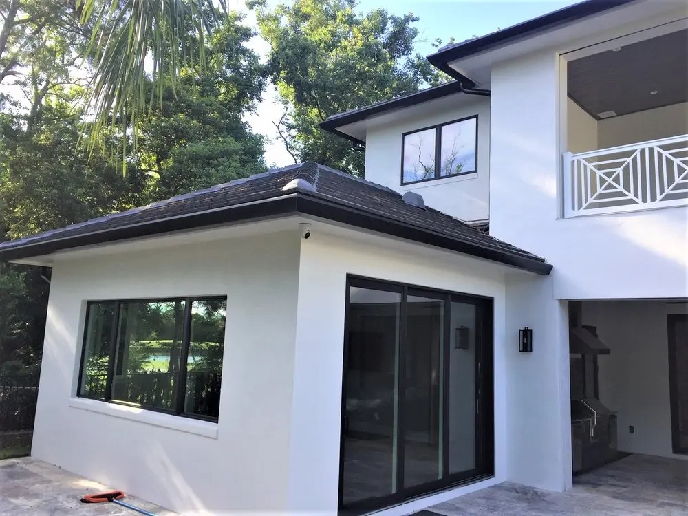 Modern residential property with newly installed seamless gutter and drainage system