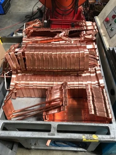 Custom copper gutter brackets and components prepared for installation project