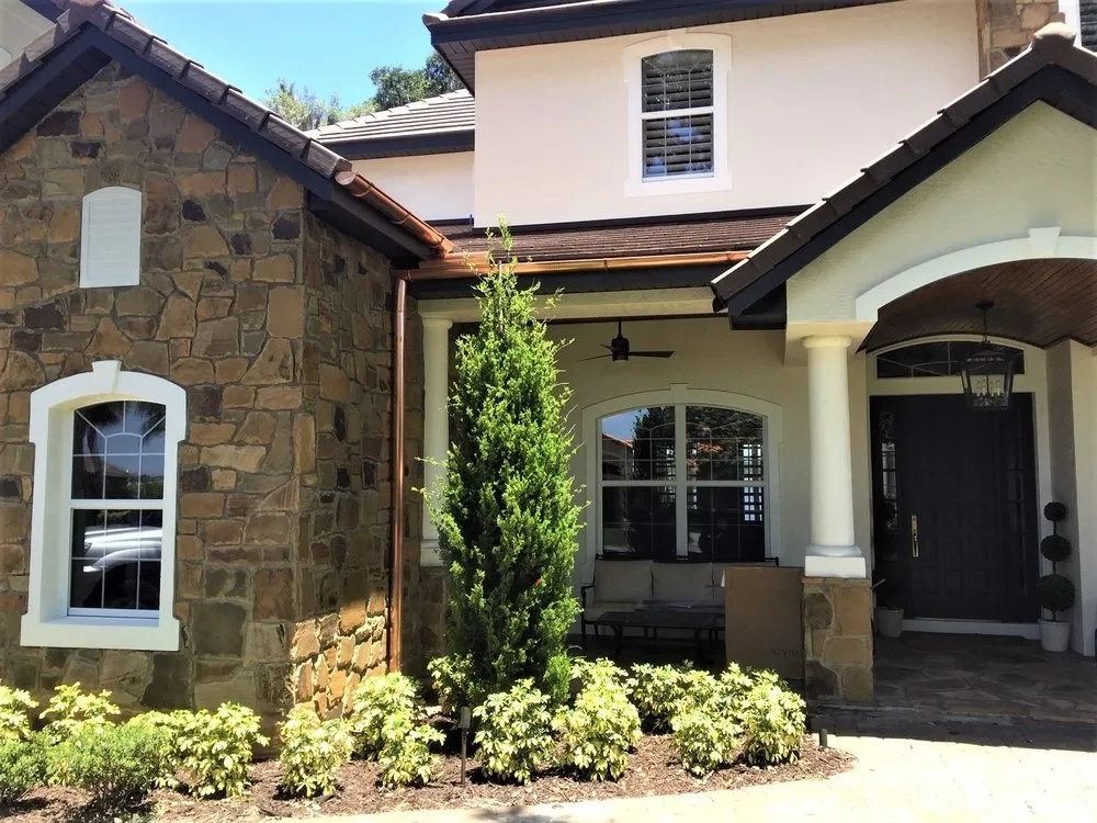 Copper gutter system installed on luxury stone and stucco residential home