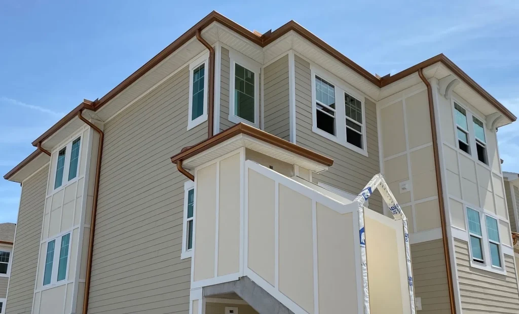 Precision Gutters FL seamless gutter installation on a Florida new construction property with custom copper-colored gutters and downspouts.