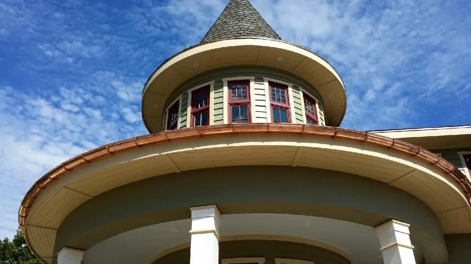 Precision Gutters FL specialty copper gutter installation on a custom Florida home with curved architectural features and premium craftsmanship.