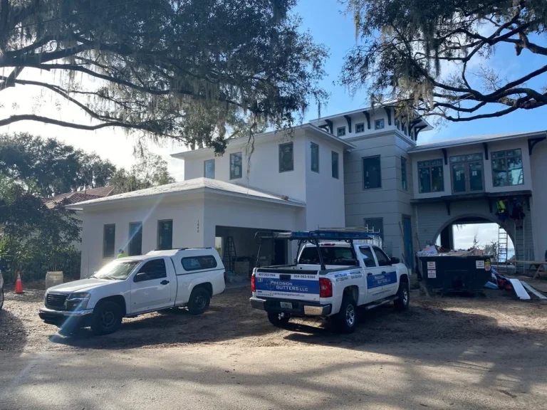 Precision Gutters FL crew working on seamless gutter installation for a high-end custom home in Central Florida.