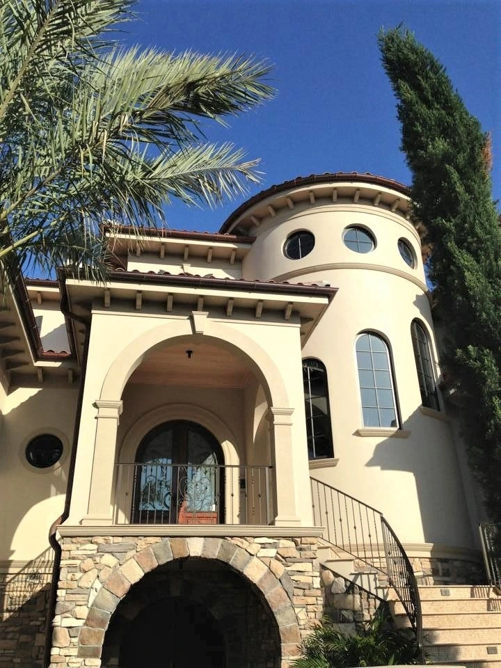 Luxury Mediterranean-style home with custom seamless gutter installation