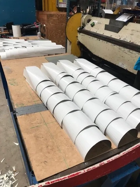 White seamless gutter components prepared for residential installation projects